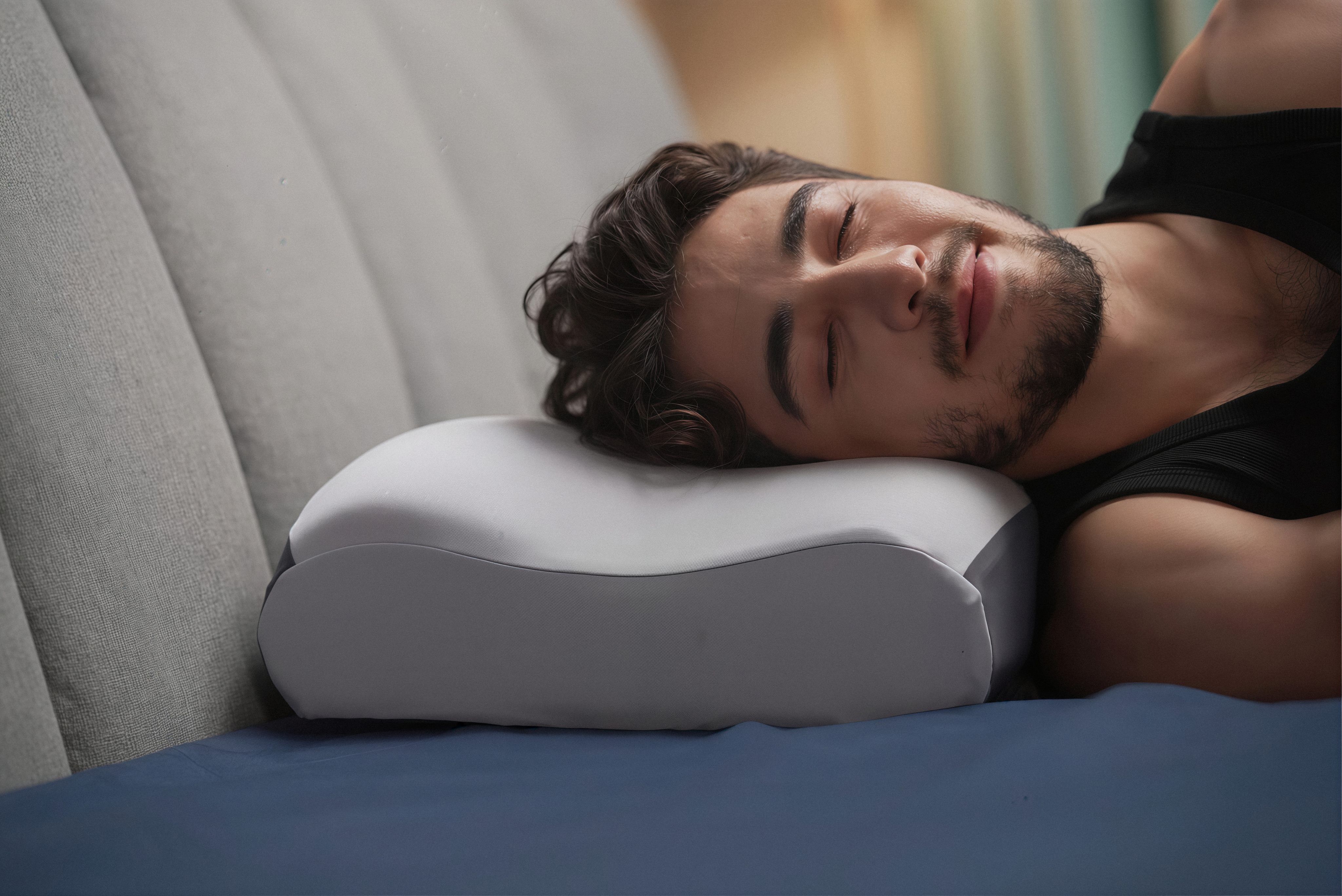 A side sleeper resting on the contoured Sleepria pillow